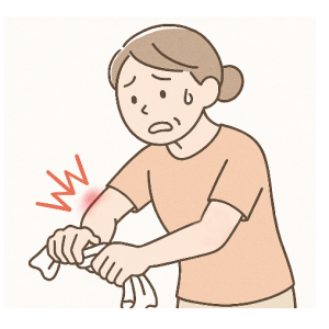 タオルを絞ると肘の外側が痛む女性